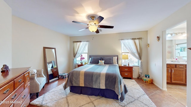 tiled bedroom featuring ceiling fan and ensuite bathroom