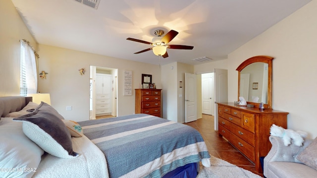 tiled bedroom featuring ceiling fan