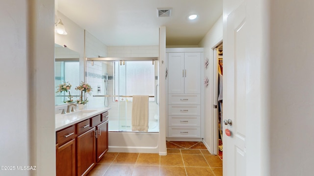 bathroom featuring vanity, shower / bath combination with glass door, and tile patterned flooring