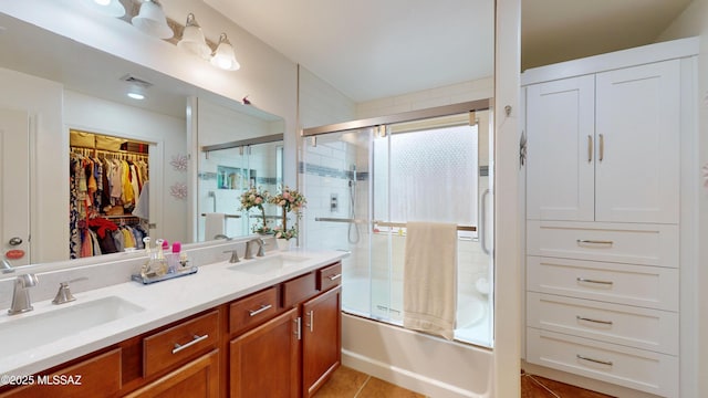 bathroom with vanity, combined bath / shower with glass door, and tile patterned floors