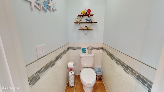 bathroom with tile walls and toilet