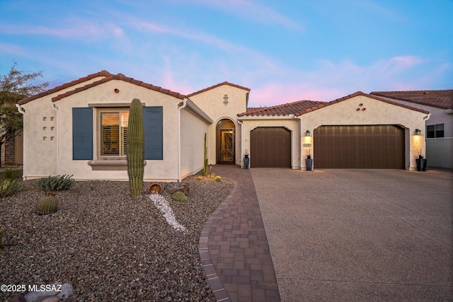 mediterranean / spanish house featuring a garage