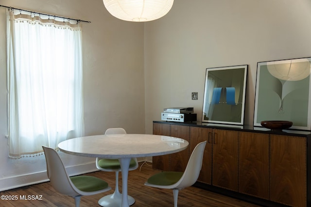 dining space with dark hardwood / wood-style flooring