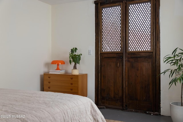 bedroom featuring concrete floors