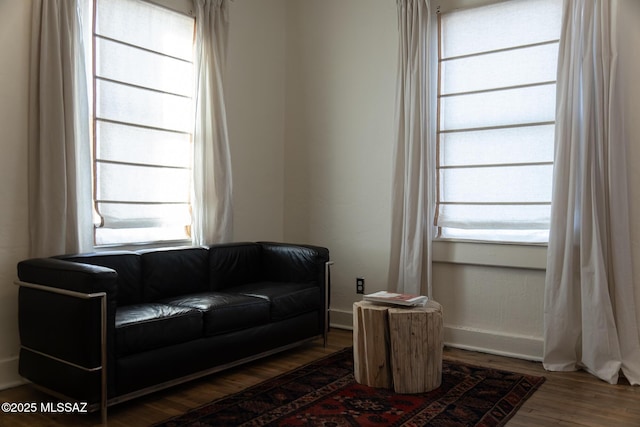 sitting room with dark wood-type flooring