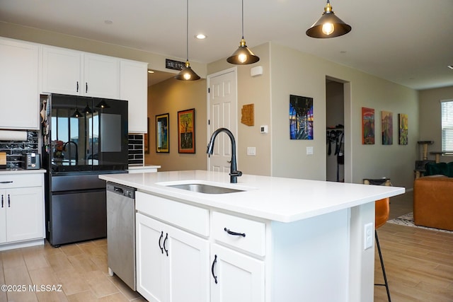 kitchen with sink, decorative light fixtures, stainless steel dishwasher, a kitchen island with sink, and white cabinets