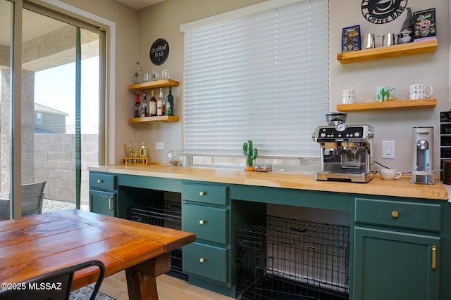 kitchen featuring butcher block countertops and green cabinetry