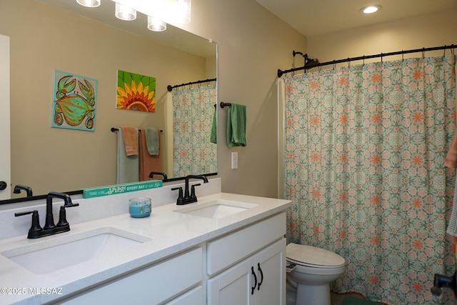 bathroom featuring vanity, curtained shower, and toilet