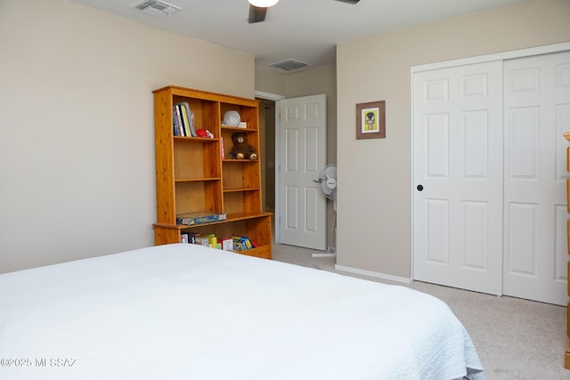 carpeted bedroom featuring ceiling fan and a closet