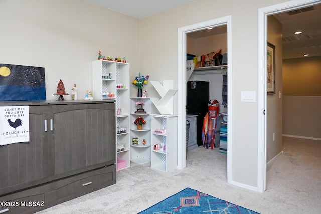 bedroom featuring carpet, a spacious closet, and a closet