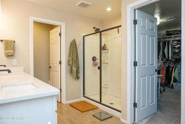 bathroom with vanity and a shower with shower door