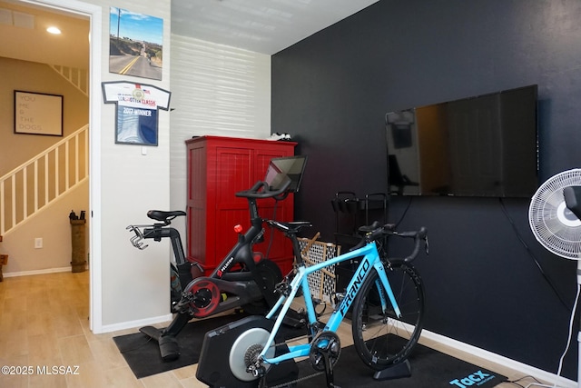 workout room with light hardwood / wood-style flooring