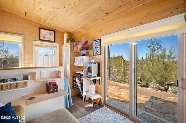 interior space featuring lofted ceiling, wooden walls, hardwood / wood-style floors, and wooden ceiling