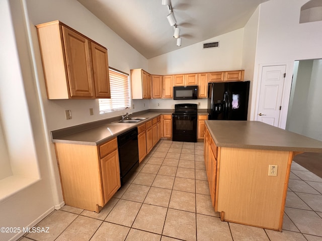 kitchen with vaulted ceiling, sink, a center island, light tile patterned floors, and black appliances