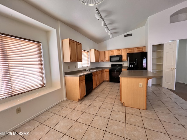 kitchen with a breakfast bar, sink, a center island, light tile patterned floors, and black appliances