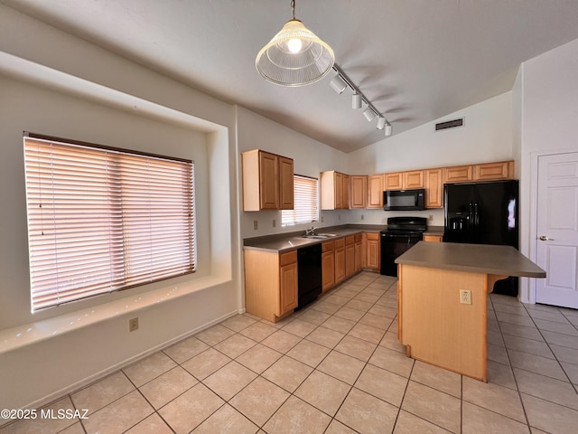 kitchen with a kitchen island, pendant lighting, a breakfast bar area, light tile patterned floors, and black appliances