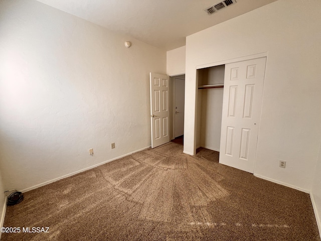 unfurnished bedroom with a closet and carpet