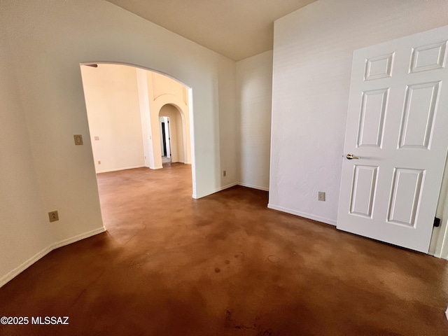 unfurnished room with dark carpet