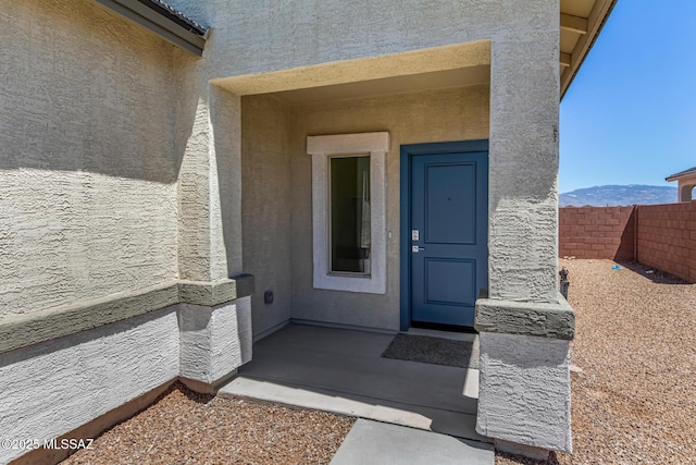 view of exterior entry with a mountain view