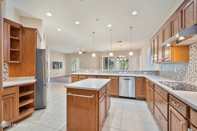 kitchen featuring a kitchen island, pendant lighting, decorative backsplash, kitchen peninsula, and stainless steel appliances