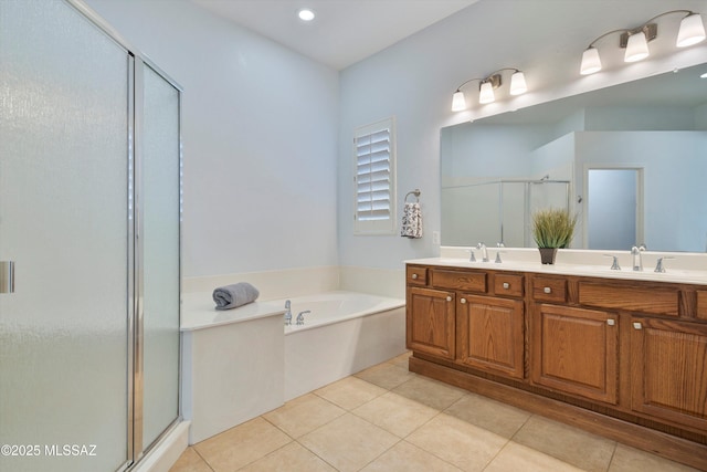 bathroom with tile patterned flooring, vanity, and independent shower and bath