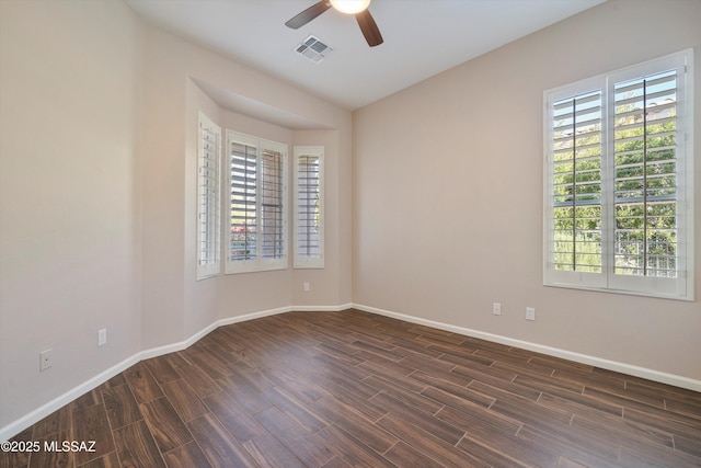 empty room with dark wood-type flooring and ceiling fan