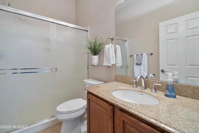 bathroom with vanity, tile patterned floors, a shower with door, and toilet