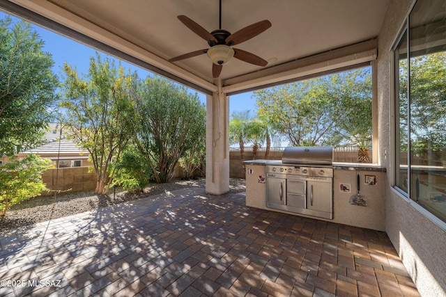 view of patio / terrace featuring exterior kitchen, grilling area, and ceiling fan