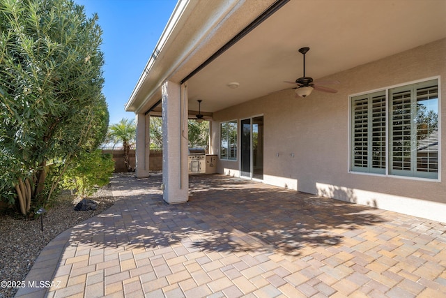 view of patio featuring ceiling fan and exterior kitchen