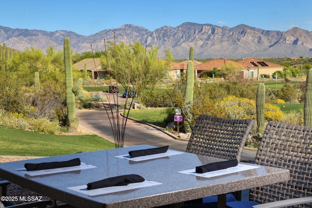 view of community with a mountain view and a yard