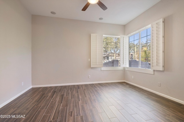 spare room featuring dark wood-type flooring and ceiling fan