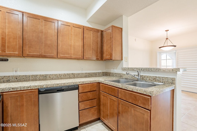 kitchen with sink, dishwasher, hanging light fixtures, light tile patterned flooring, and kitchen peninsula