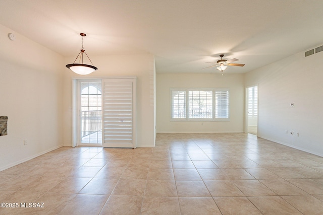 spare room with light tile patterned flooring, ceiling fan, and plenty of natural light