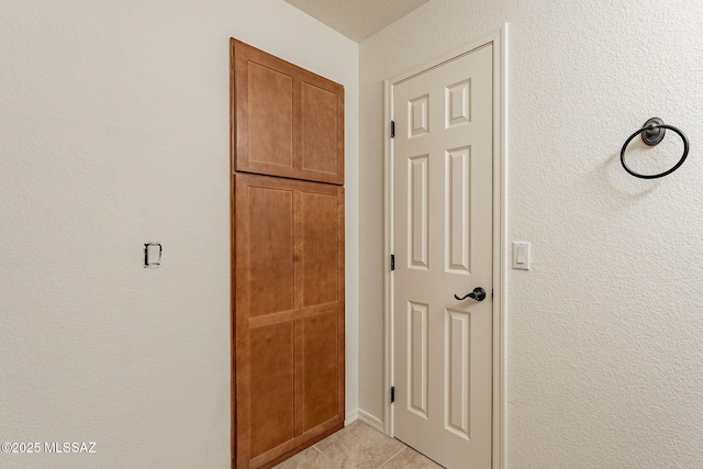 corridor featuring light tile patterned floors