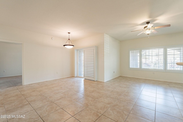 tiled empty room featuring ceiling fan