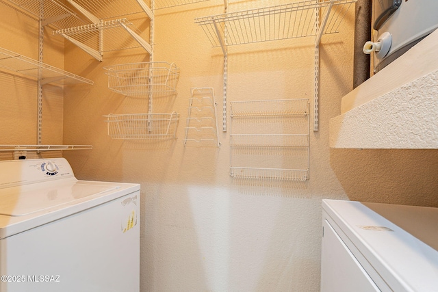 clothes washing area featuring washing machine and clothes dryer