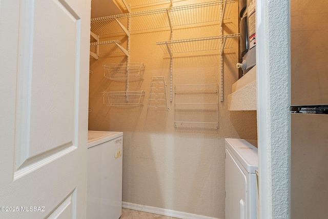 laundry room featuring washing machine and clothes dryer