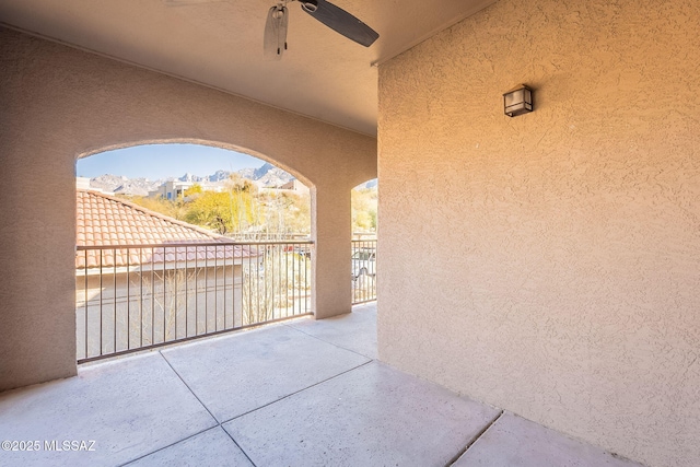 view of patio with a balcony and ceiling fan