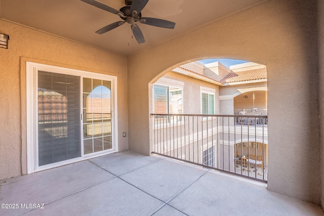 view of patio with a balcony and ceiling fan