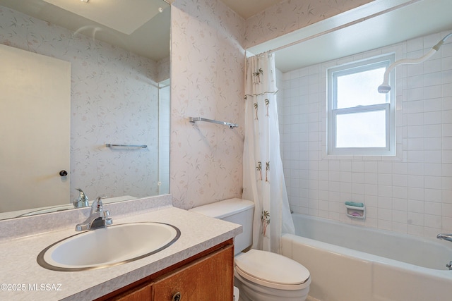 bathroom featuring shower / bathtub combination with curtain, vanity, toilet, and wallpapered walls