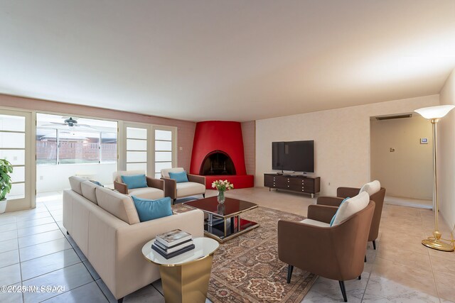 unfurnished living room with a brick fireplace and light tile patterned flooring