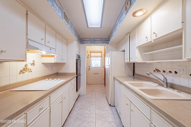 kitchen featuring sink, white cabinetry, light tile patterned floors, white appliances, and backsplash