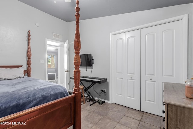 bedroom featuring light tile patterned flooring and a closet