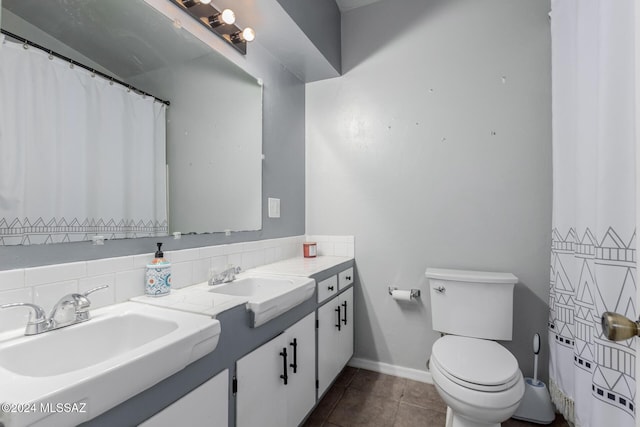 bathroom with decorative backsplash, vanity, tile patterned floors, and toilet