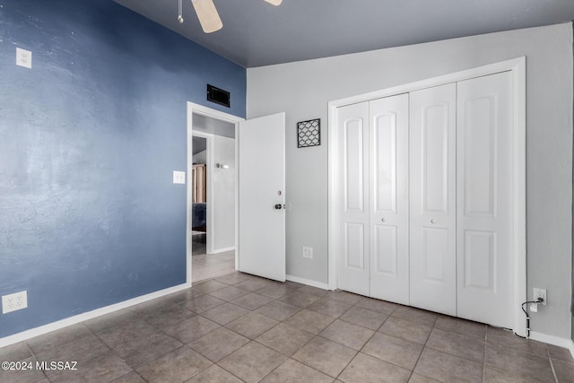 unfurnished bedroom with vaulted ceiling, tile patterned floors, ceiling fan, and a closet