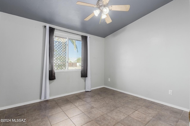 spare room featuring tile patterned flooring and ceiling fan