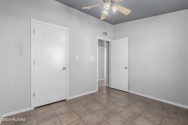 unfurnished bedroom featuring light tile patterned floors and ceiling fan