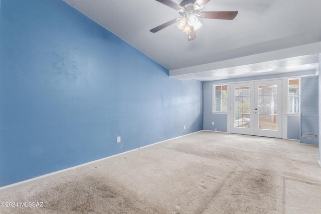 carpeted spare room with french doors and ceiling fan