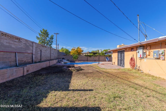 view of yard featuring a fenced in pool and a patio area