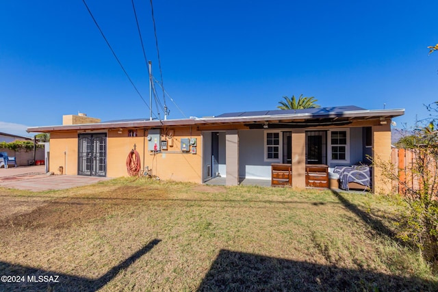 single story home featuring a front yard and a patio area